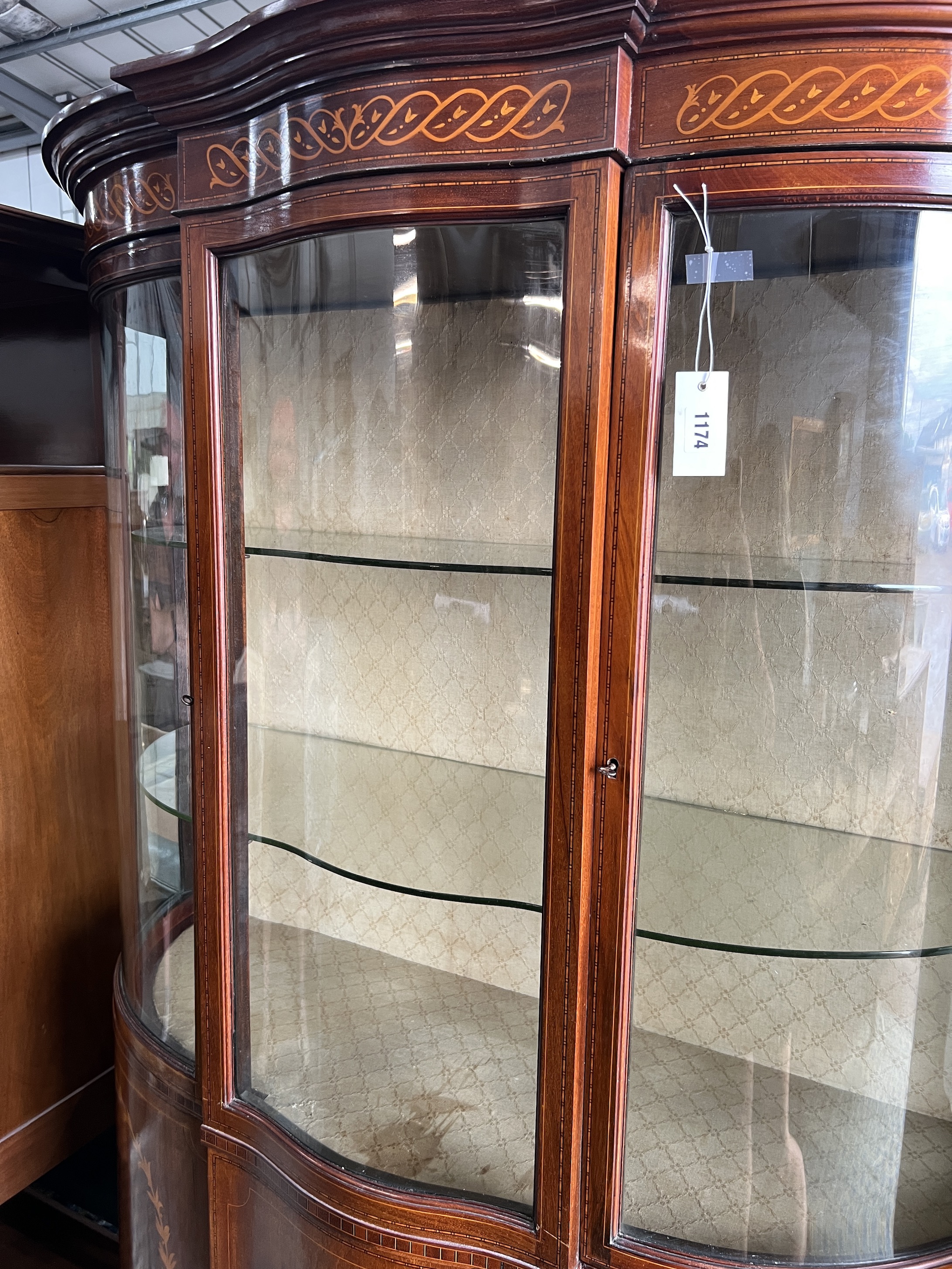 An Edwardian marquetry inlaid mahogany bowfront display cabinet, width 118cm, depth 48cm, height 185cm